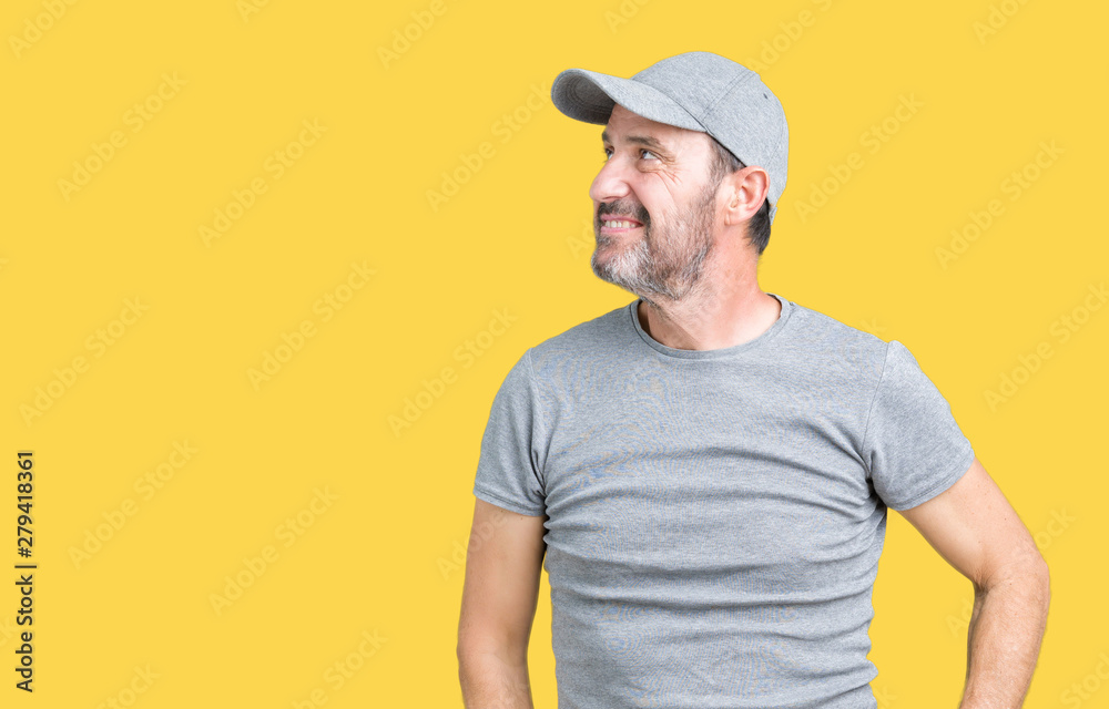 Handsome middle age hoary senior man wearing sport cap over isolated background looking away to side with smile on face, natural expression. Laughing confident. Handsome middle age hoary senior man wearing sport cap over isolated background looking away to side with smile on face, natural expression. Laughing confident.