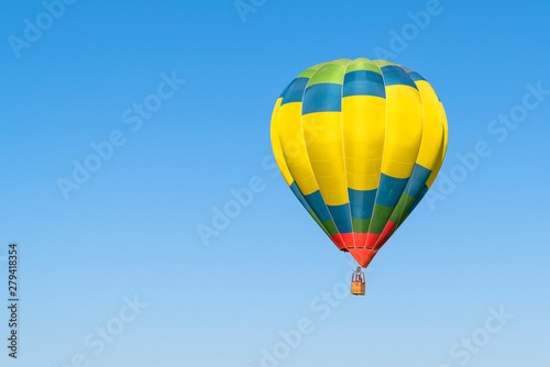 One colorful hot air balloon in blue sky