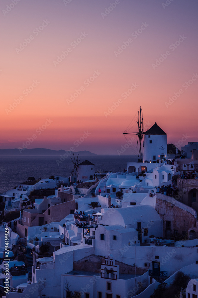 Fototapeta premium The white village of Oia, on the island of Santorini, Greece during a romantic red sunset.
