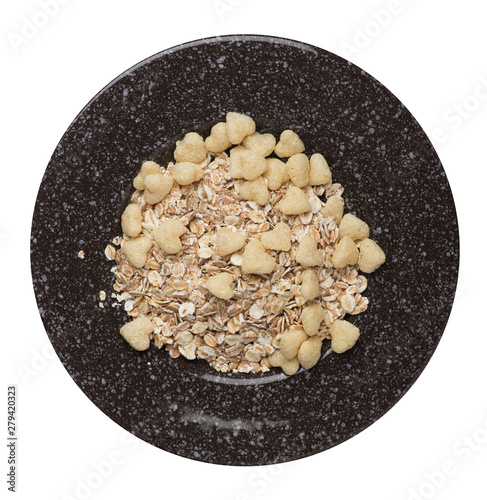  healthy breakfast on a plate isolated on white background.muesli with cornflakes, raisins, dates, pears and pineapple dried cashew nuts.breakfast top view photo