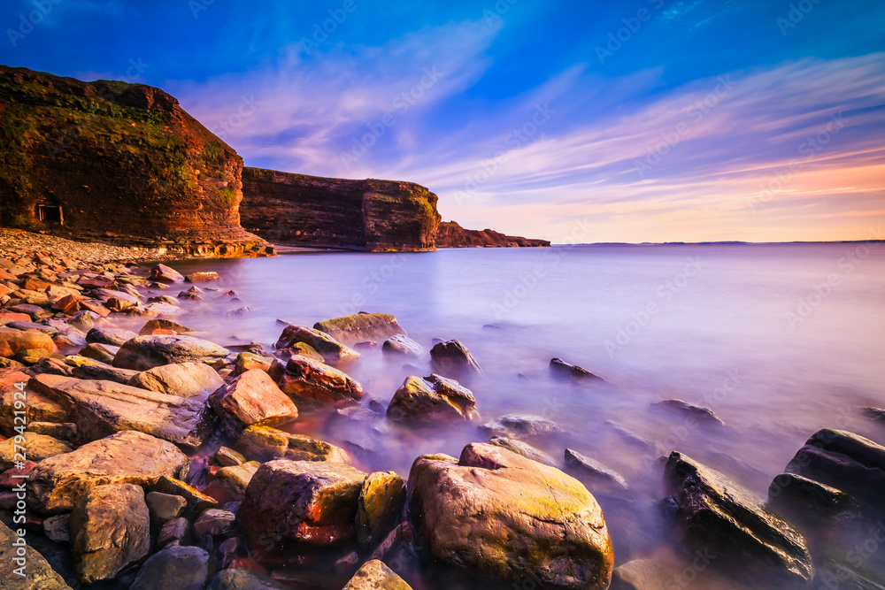 View of a beach at Bell Island, Newfoundland, Canada during sunset View of a beach at Bell Island, Newfoundland, Canada during sunset