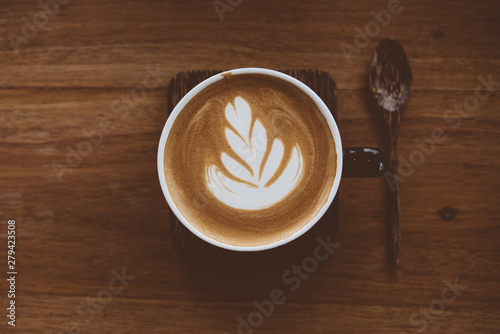 Cup of coffee latte with beautiful latte art on wood table background,topview.