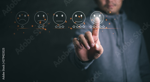 Cuadro en lienzo Businessman pressing smiley face emoticon on virtual touch screen