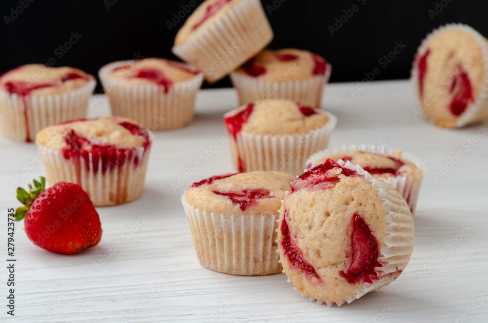 homemade muffins with fresh strawberries close-up on the table homemade muffins with fresh strawberries close-up on the table