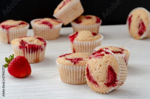 homemade muffins with fresh strawberries close-up on the table