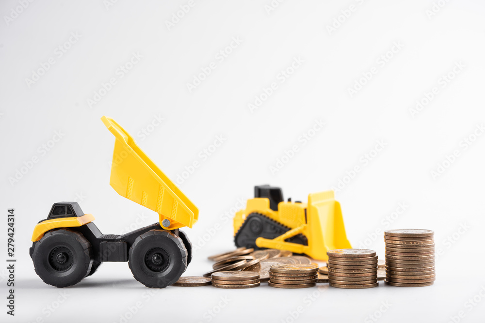 Close up of stacking coins with Tipper truck and tractor,investment concept. Close up of stacking coins with Tipper truck and tractor,investment concept.