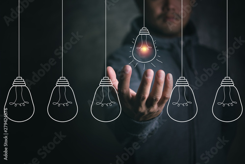 Businessman Houlding light bulb photo