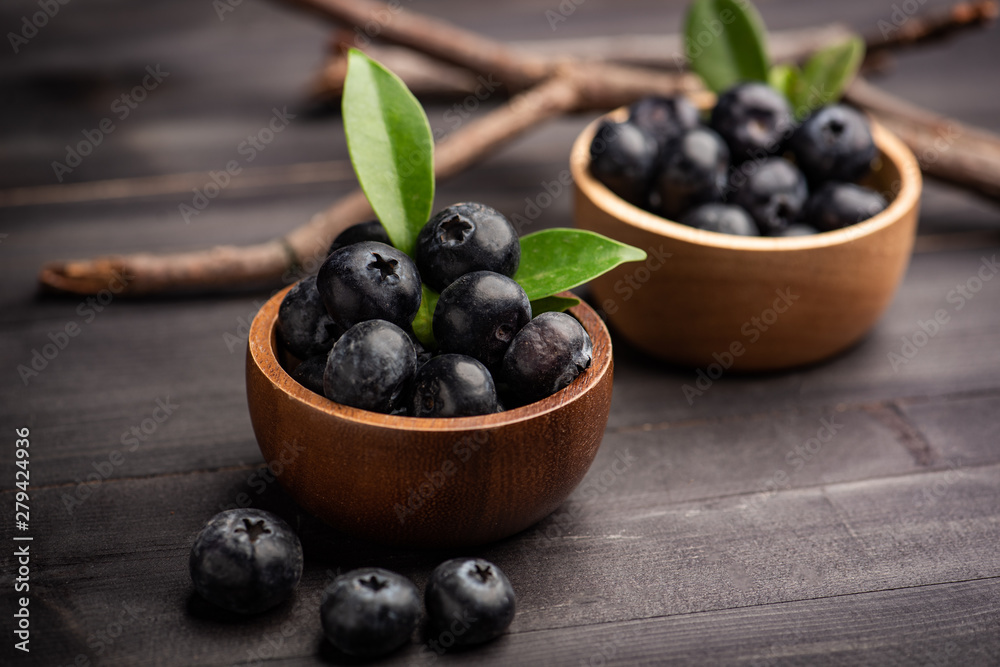 Blueberry on dark wooden table. Blueberries in wooden bowl, Blue berry detail Blueberry on dark wooden table. Blueberries in wooden bowl, Blue berry detail