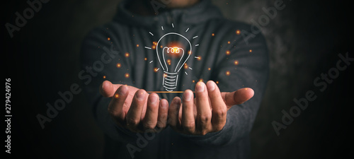 man holding icon light bulb,idea concept,,Presenting new ideas.