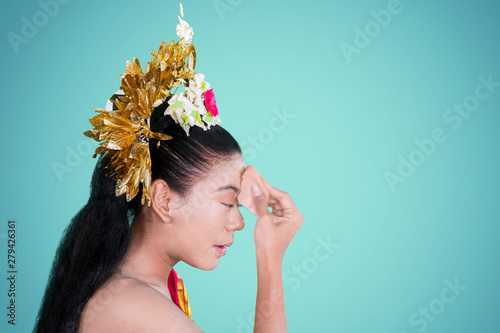 Dancer using sponge to apply makeup on face photo