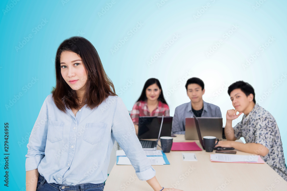 Female entrepreneur stands with her team on studio Female entrepreneur stands with her team on studio