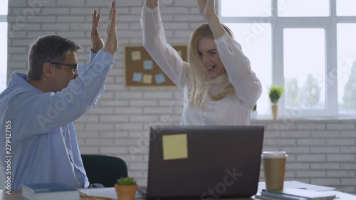 Happy businessman feeling excited looking at laptop screen sitting at workplace, celebrates business success, online win, positive good news in email, positive result, passed exam, got job, being