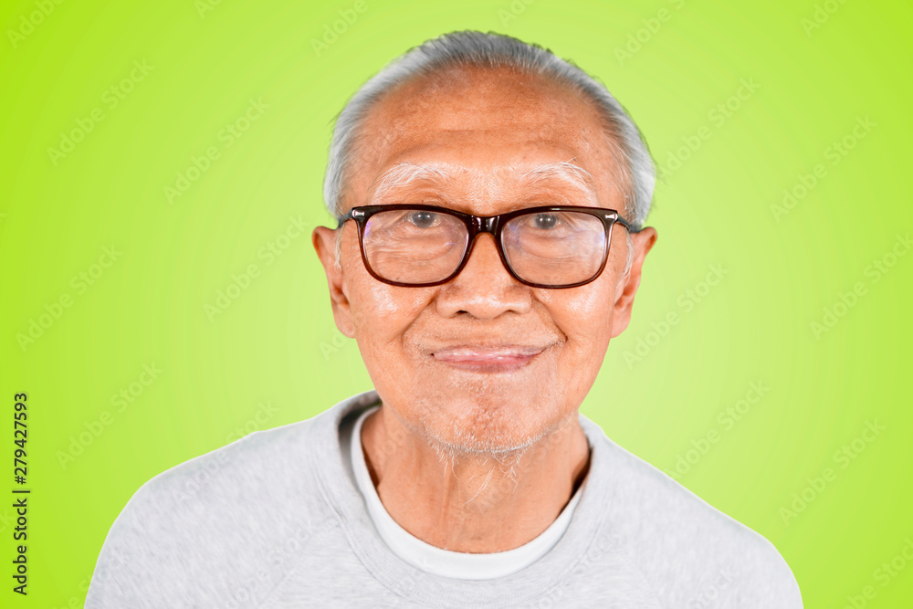 Old man showing his tongue in the studio Old man showing his tongue in the studio