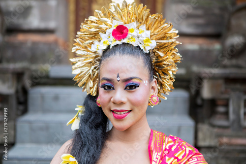 Young balinese dancer smiling in the temple photo