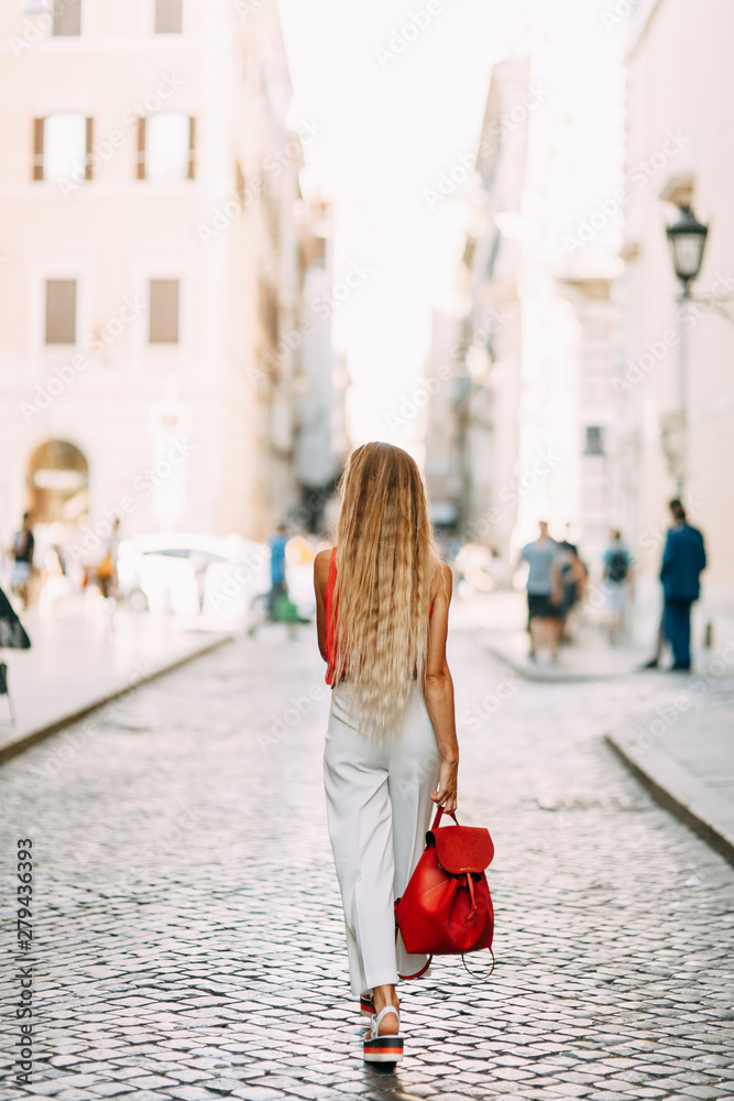 Sights and atmospheric places in Italy. Girl traveler on the streets of Rome.
