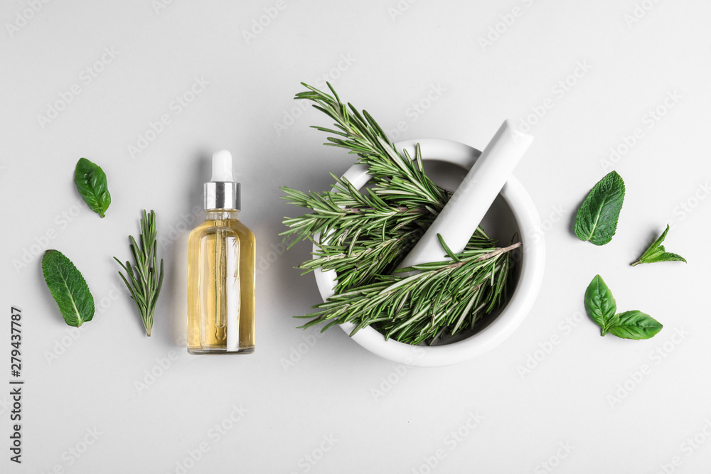 Flat lay composition with herbal essential oil on light background - obrazy, fototapety, plakaty 