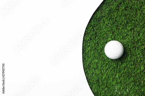 Fototapeta Golf ball and white paper on green artificial grass, top view with space for tex