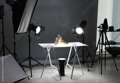 Картината върху платно Professional photography equipment prepared for shooting stylish shoes in studio