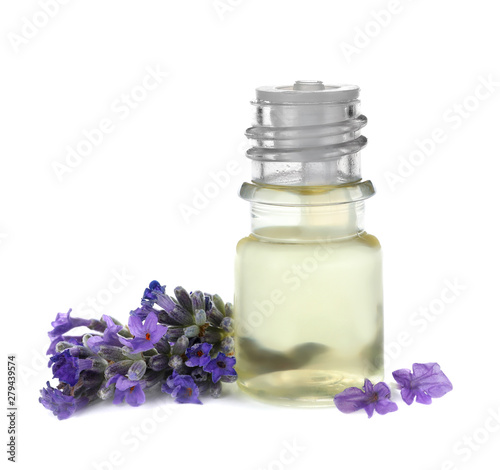 Bottle with natural lavender oil and flowers on white background