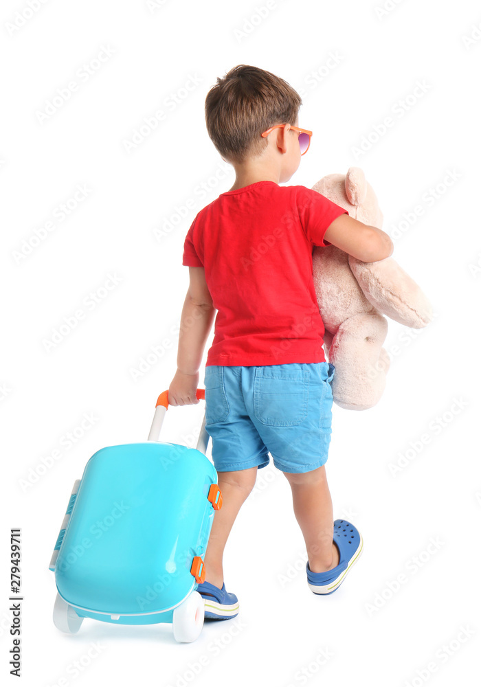 Cute little boy with toy and blue suitcase on white background Cute little boy with toy and blue suitcase on white background