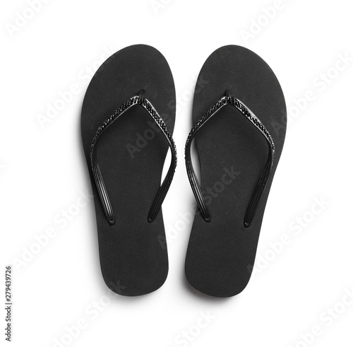 Pair of stylish flip flops on white background, top view
