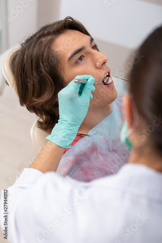 Relaxed young patient sitting in a dental chair