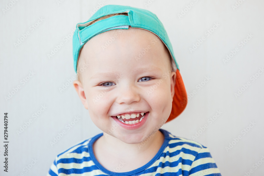 Smiling little boy with a cap and blue eyes Smiling little boy with a cap and blue eyes