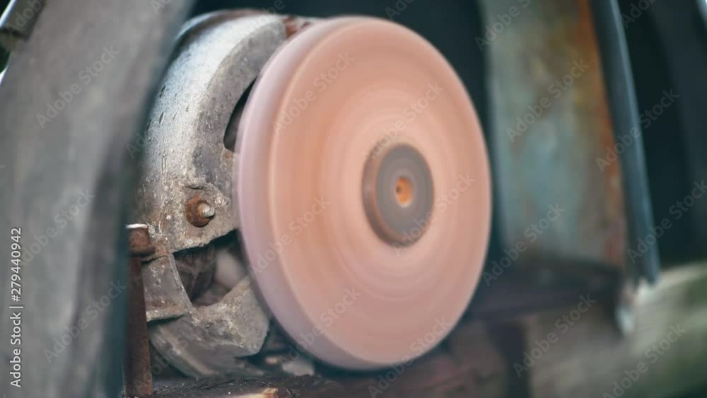 Grinder. Rotating disk of grinding machine. A machine for turning a round shape. Close-up of rotating grinding machine disc. Grinder. Rotating disk of grinding machine. A machine for turning a round shape. Close-up of rotating grinding machine disc.
