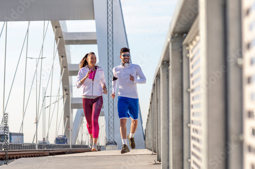 Couple jogging at the bridge