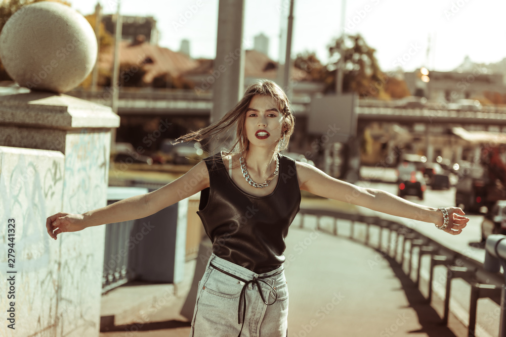 Fototapeta premium Active long-haired photo model spreading hands and rolling around