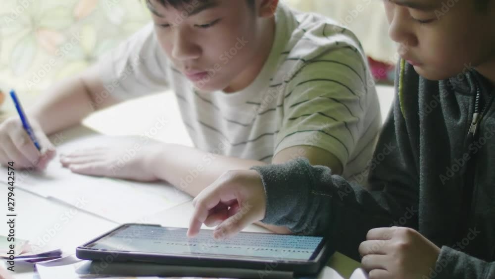 Happy little boy doing your homework. Child sitting at the desk at home and doing his homework. School, children, education concept