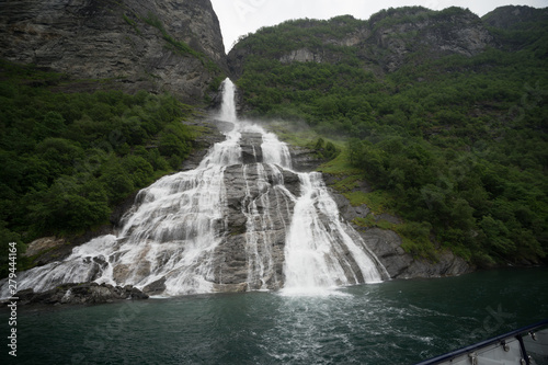 Geirangerfjord seen from the sea safari ride. Bridal veil waterfall (also known as  Brudesloret) with a height of approximately 300 meters. Norway, Scandinavia.