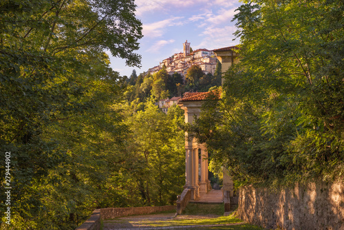 Old and famous Italian medieval village. Sacro Monte of Varese with the holy road that leads to medieval village (in the background), with the eleventh chapel. World Heritage Site – Unesco