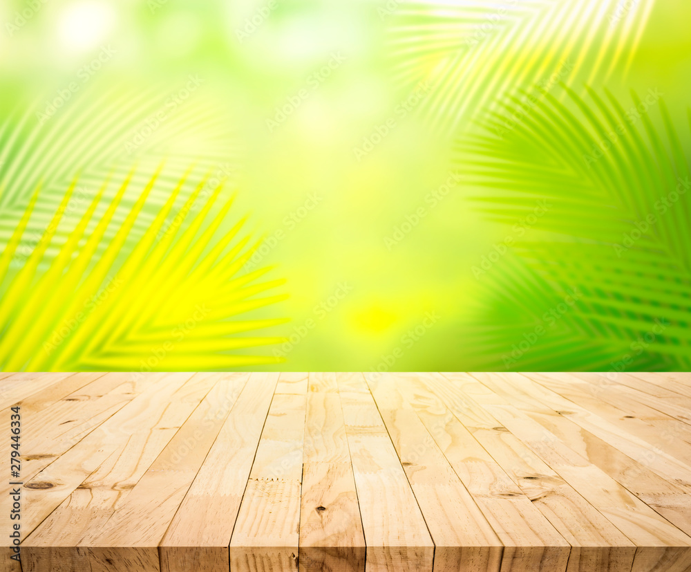 Summer and nature product display with wood table counter on blur coconut leaf background Summer and nature product display with wood table counter on blur coconut leaf background
