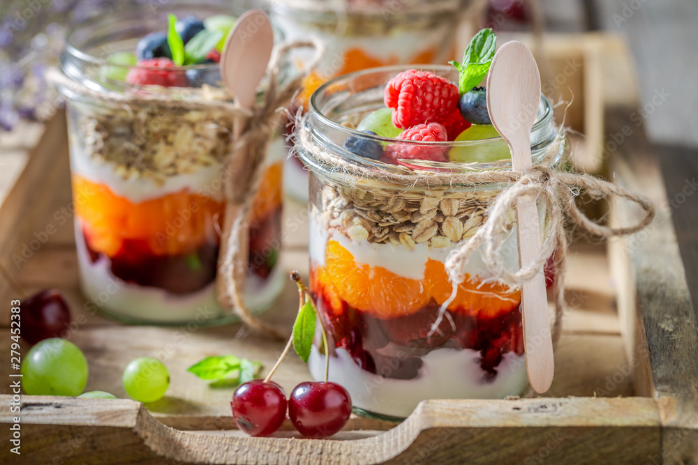 Homemade granola in jar with yoghurt and fresh berries Homemade granola in jar with yoghurt and fresh berries