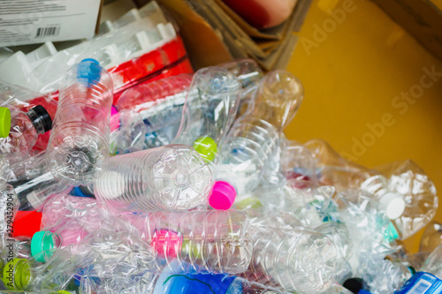 plastic bottles and cardboard paper in recycle trash station close up