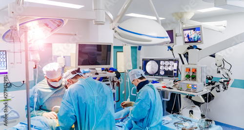 Spinal surgery. Group of surgeons in operating room with surgery equipment. Laminectomy. Modern medical background