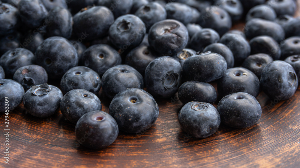 Blueberries and blueberries on the background of pottery. Black berries. Blueberries and blueberries on the background of pottery. Black berries.