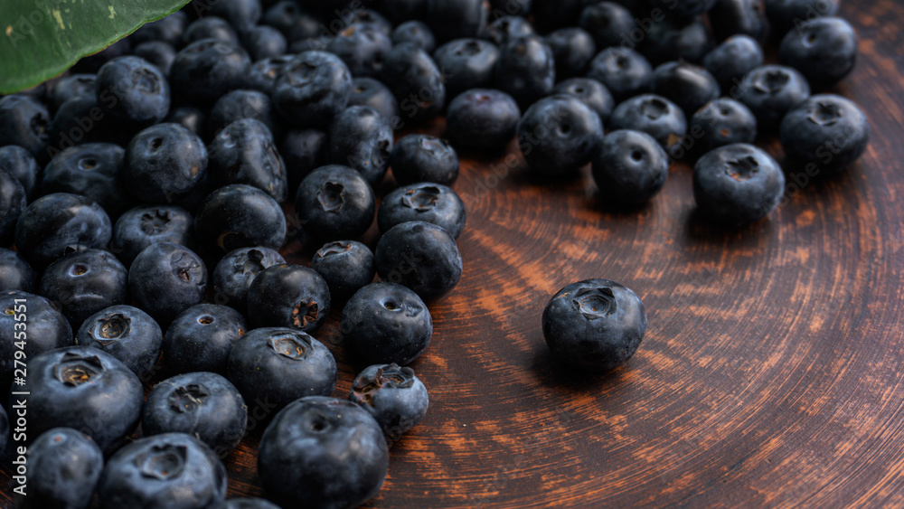 Blueberries and blueberries on the background of pottery. Black berries. Blueberries and blueberries on the background of pottery. Black berries.