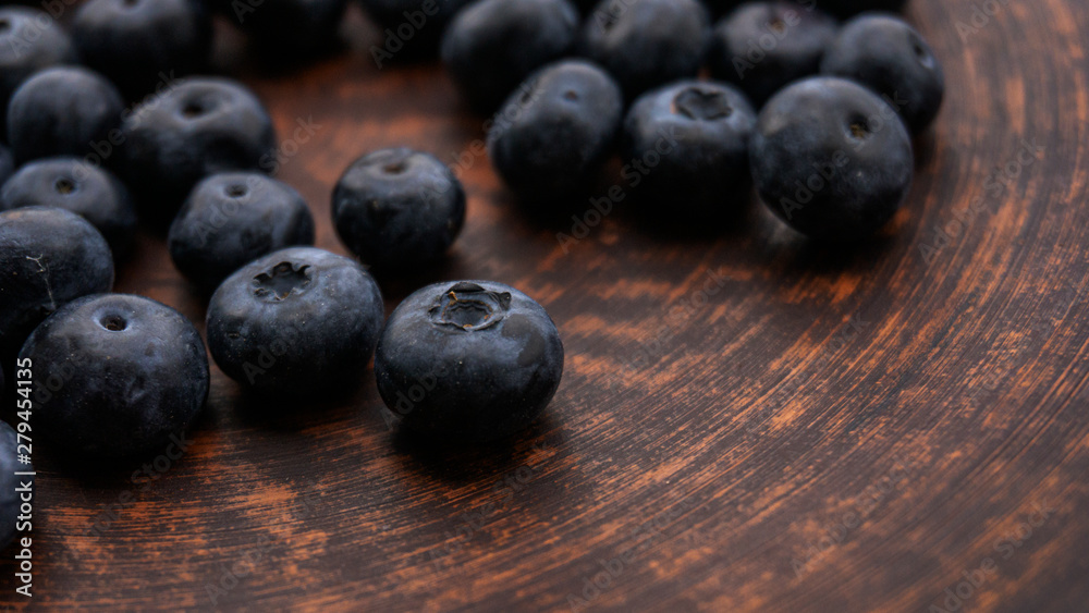 Blueberries and blueberries on the background of pottery. Black berries. Blueberries and blueberries on the background of pottery. Black berries.