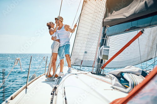 Romantic vacation and luxury travel. Young man and woman enjoying on luxury boat.