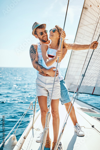 Romantic man with girl on a yacht enjoy bright sunny day on vacation. © luckybusiness