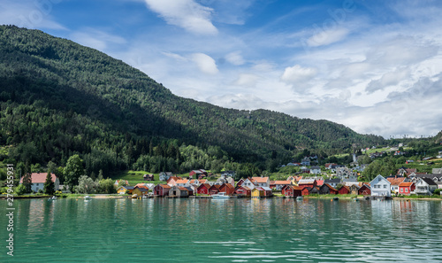 Panoramic view from the fjord at Solvorn, a cute small resort village pressed between mountains on the western shore of the Lustrafjorden (innermost part of the Sognefjorden). Midsummer day in Norway. © Ingrid