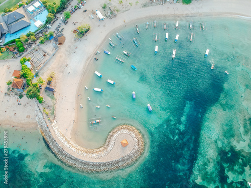 Aerial drone view of ocean, boats, beach, shore In Sanur Beach, Bali, Indonesia with with Traditional Balinese Fishing Boats amazing blue ocean. photo