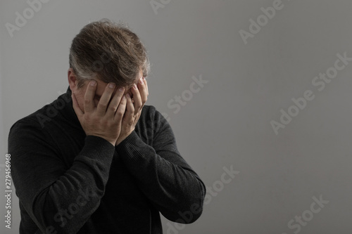 man covered his face with his hands