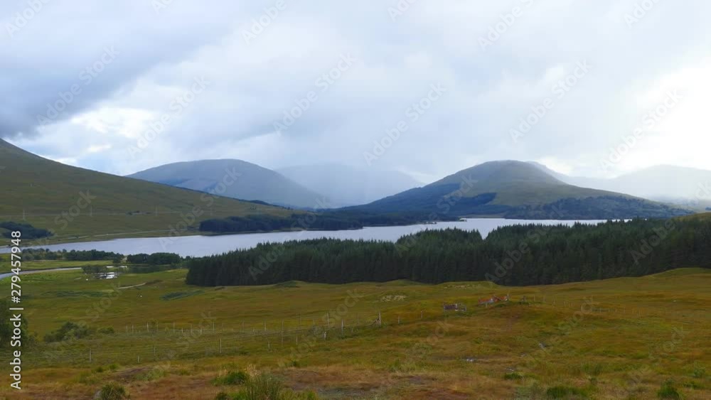 A picturesque view of a lake in a valley with mountains in the background. A picturesque view of a lake in a valley with mountains in the background.