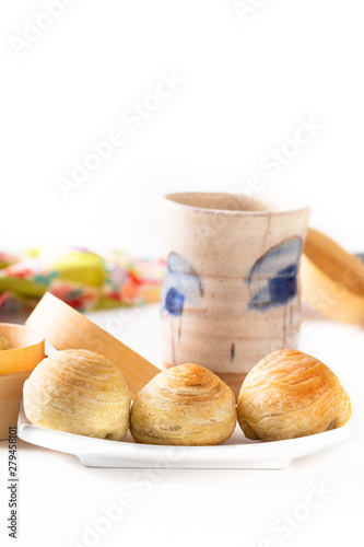 Oriental food concept homemade organic Huaiyang Spiral Chinese flaky  pastry moon cake on white background with copy space photo