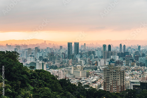 Aerial view over Downtown Taipei with layers of mountain in background in the dusk from Xiangshan Elephant Mountain in the evening.