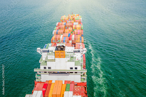 top aerial view of the large TEU containers ship heading to the port destination, carriage the shipment from loading port to destination discharging port, transport and logistic service to worldwide 