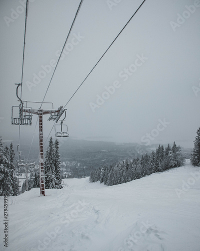 A ski lift approaching the top of the hill